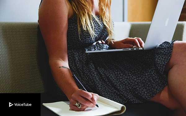 freelance woman writing her schedule down